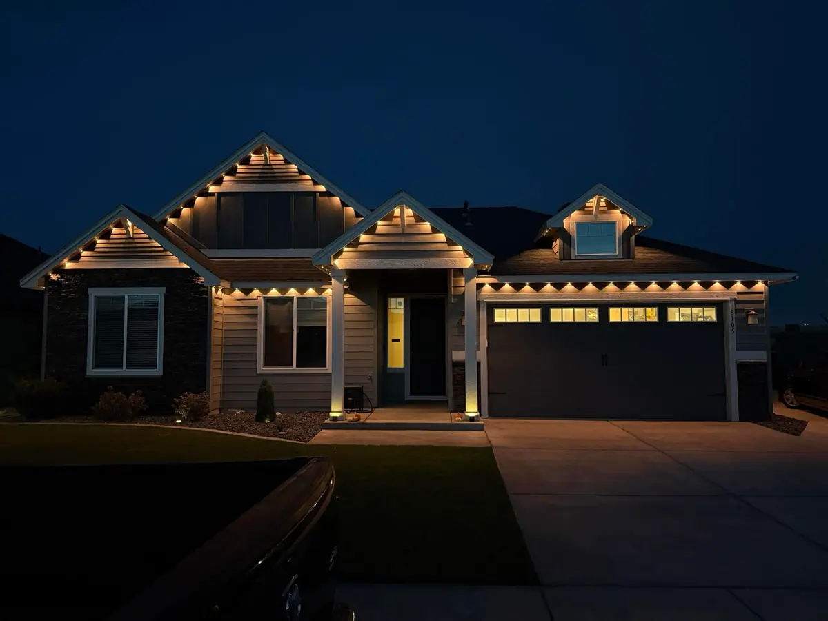 Warm white permanent Govee outdoor lights installed on a ranch home in Denver, CO with concealed aluminum channel track.