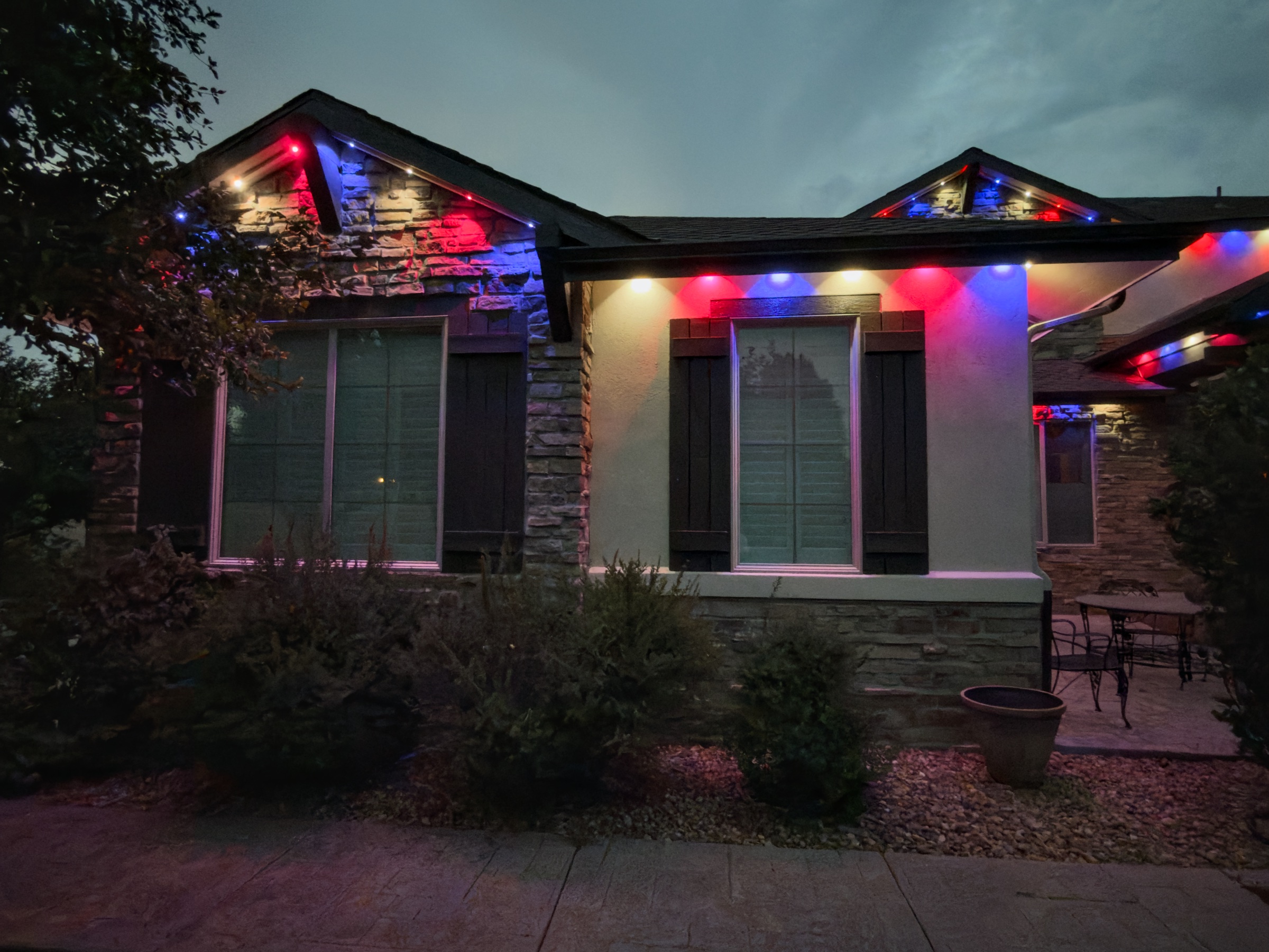 Parker CO home at night with permanent LED lights glowing along the roofline and eaves
