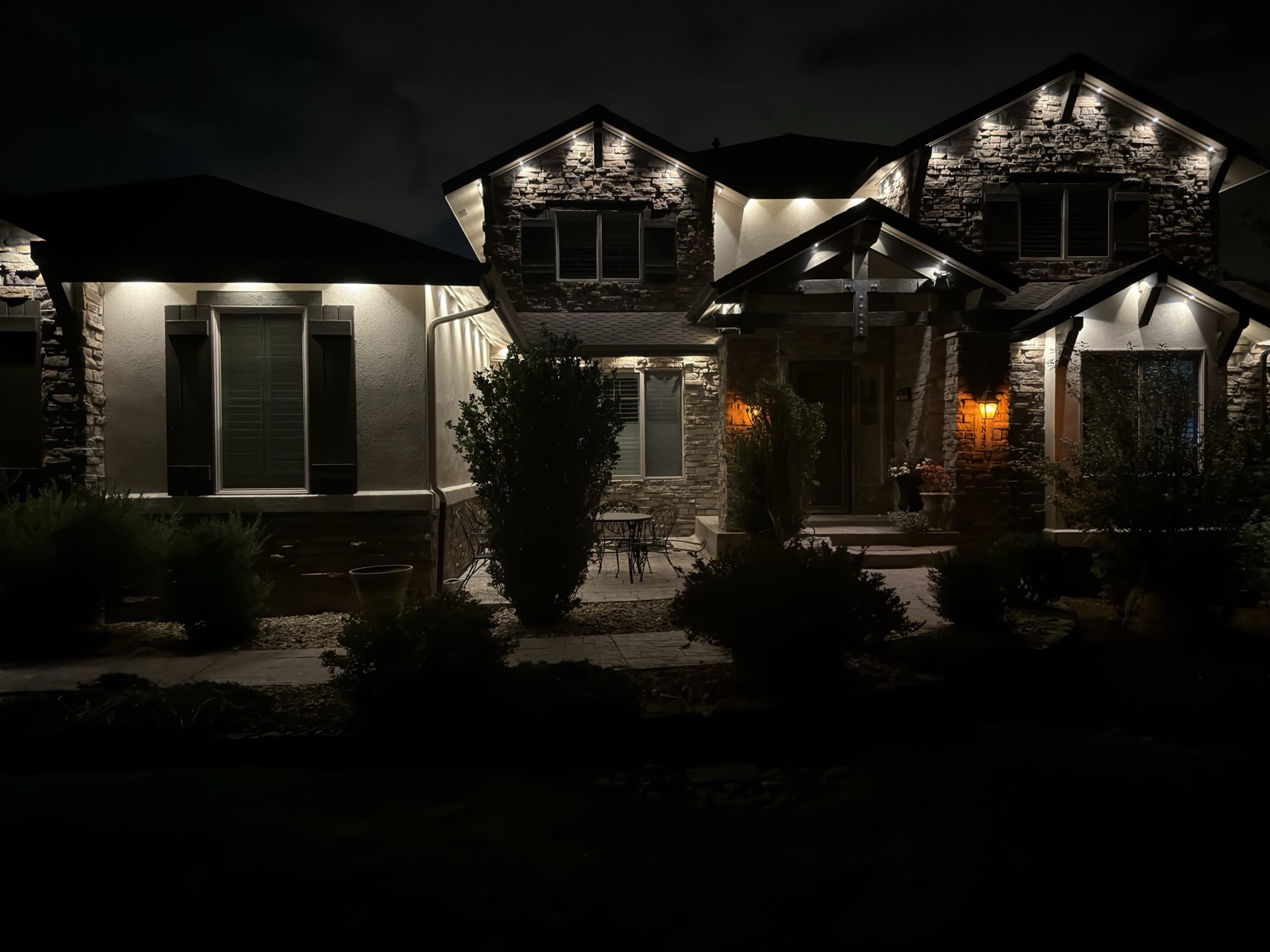 Parker CO custom home at night with warm white permanent LED lights installed along the full perimeter roofline using SnapTrack aluminum channel