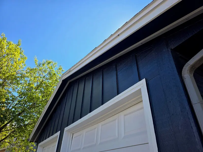 Daylight view of a navy blue home in Denver Metro with the SnapTrack channel for Govee permanent lights nearly invisible along the fascia