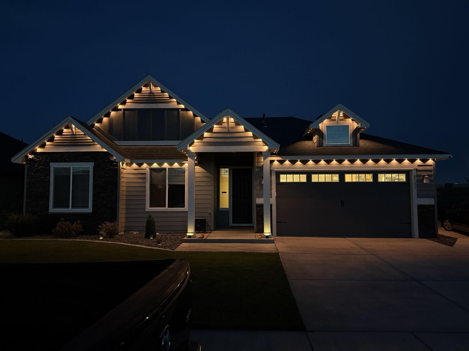 Warm white permanent Govee outdoor lights installed on a ranch home in Denver, CO with concealed aluminum channel track.
