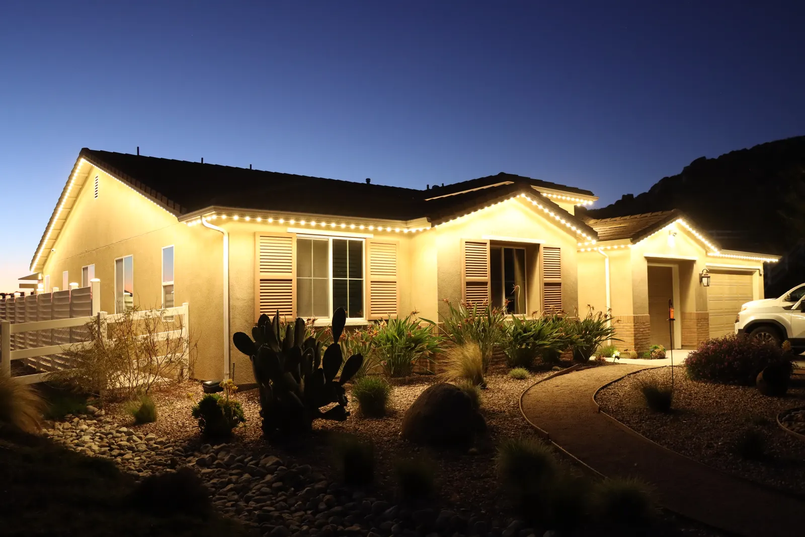 Authorized 5280 Signature system photography: a single-story home after dark, lit in warm white along every roofline