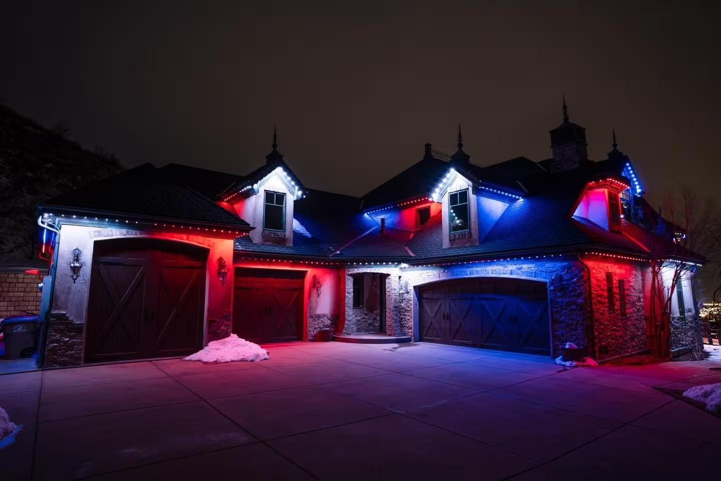 Home at night glowing with Strata permanent LED lighting installed along the roofline